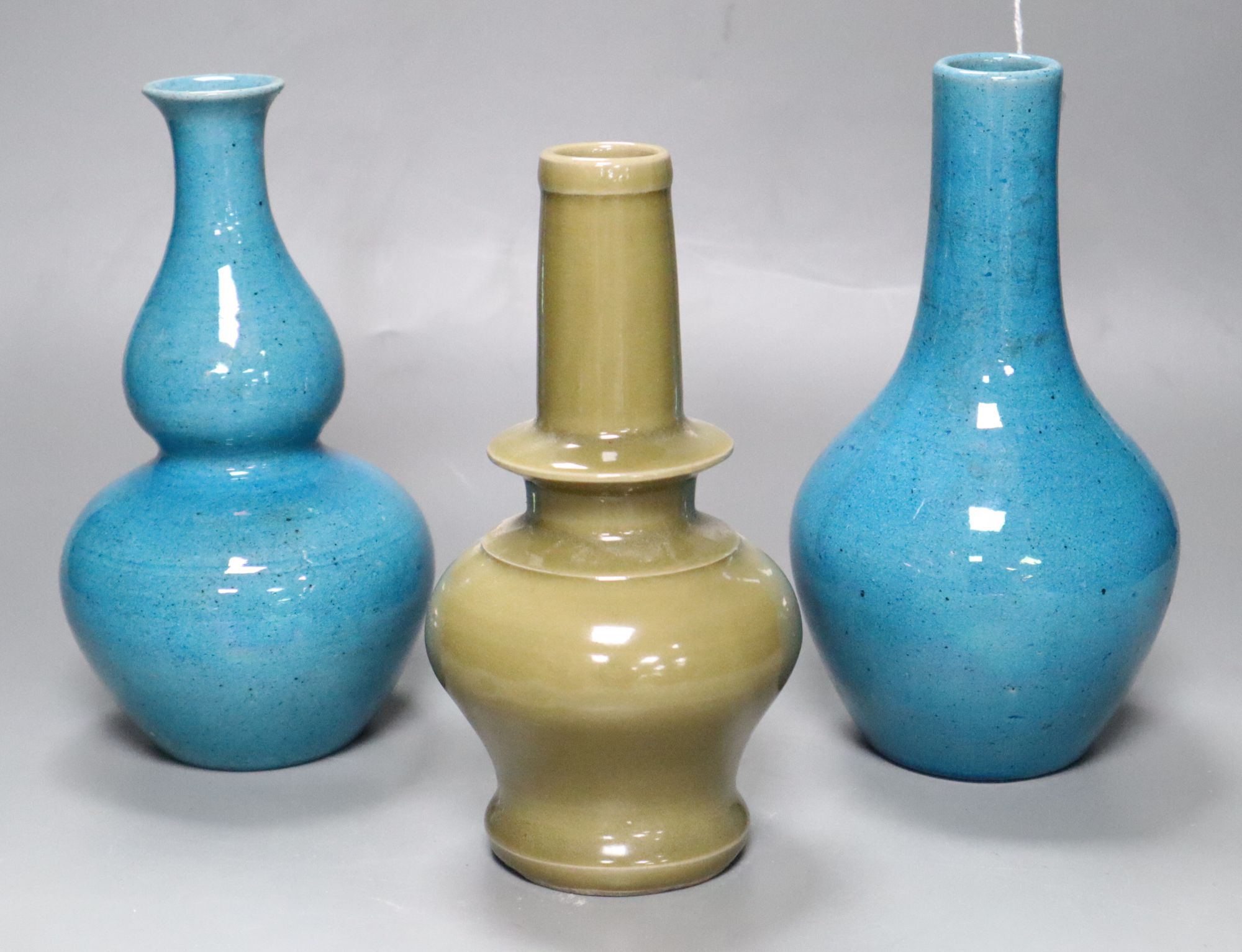 Two Chinese turquoise glazed vases and a celadon glazed bottle vase, height 20cm